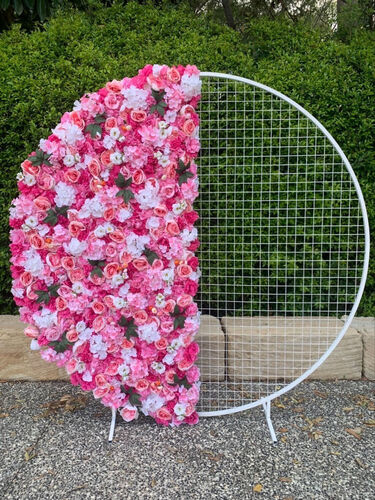 Mesh backdrop with half of it covered in pink and white florals