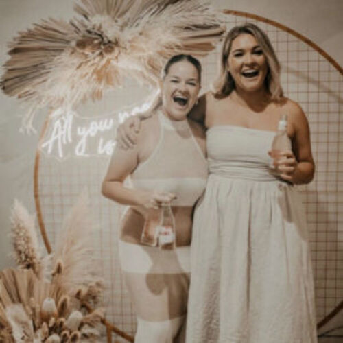 Gold mesh backdrop with people posing in front of it