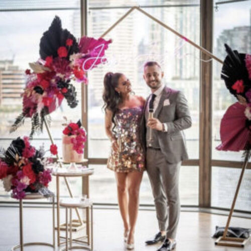 Gold pentagon arbor backdrop with pink and black decor