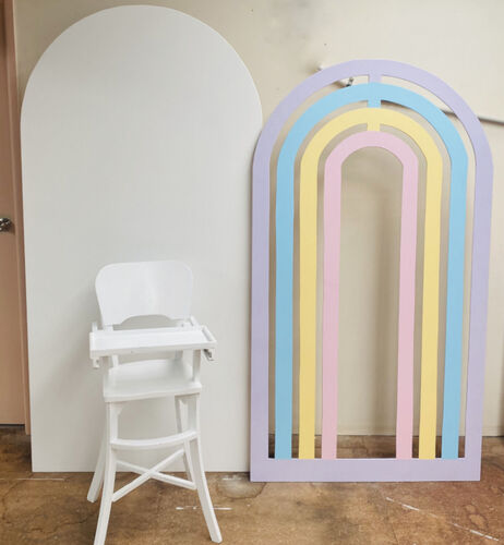 pastel rainbow arch next to solid white arch