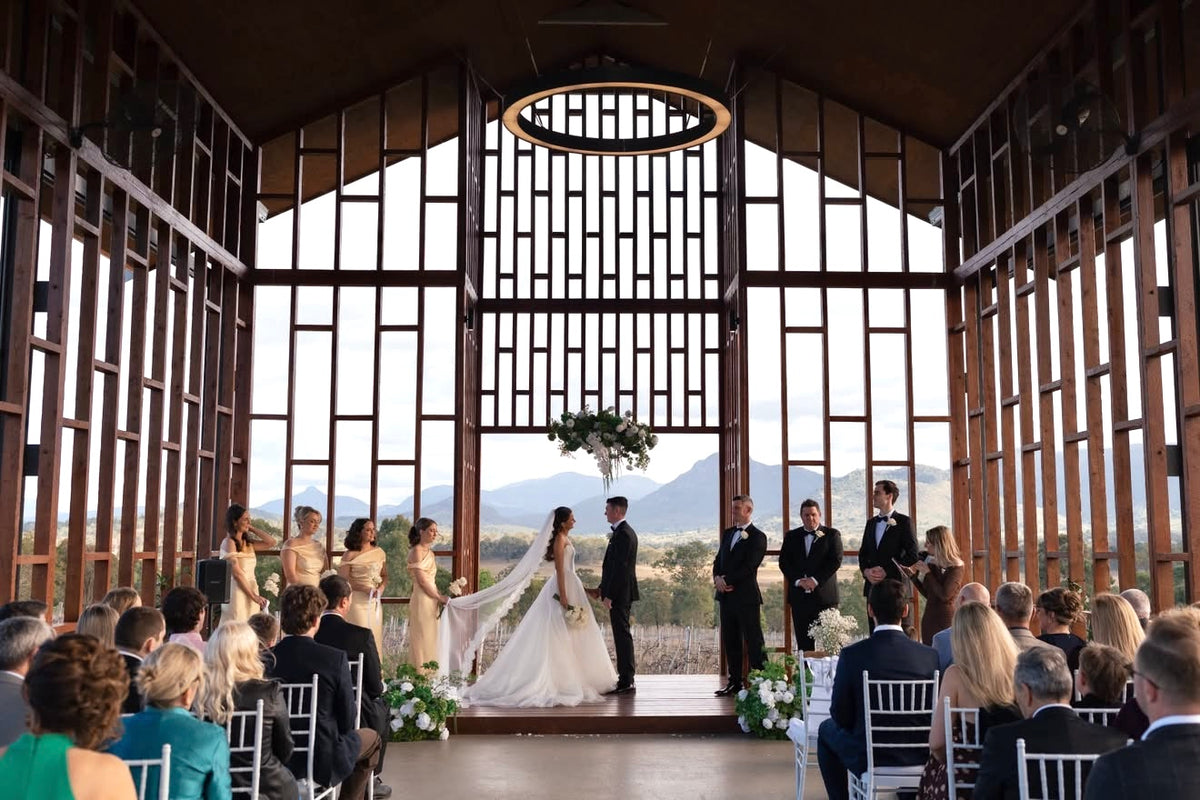 Wedding ceremony in a timber chapel styled with florals
